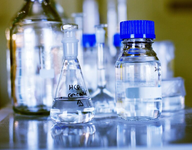 Chemicals in glass containers on table at laboratory